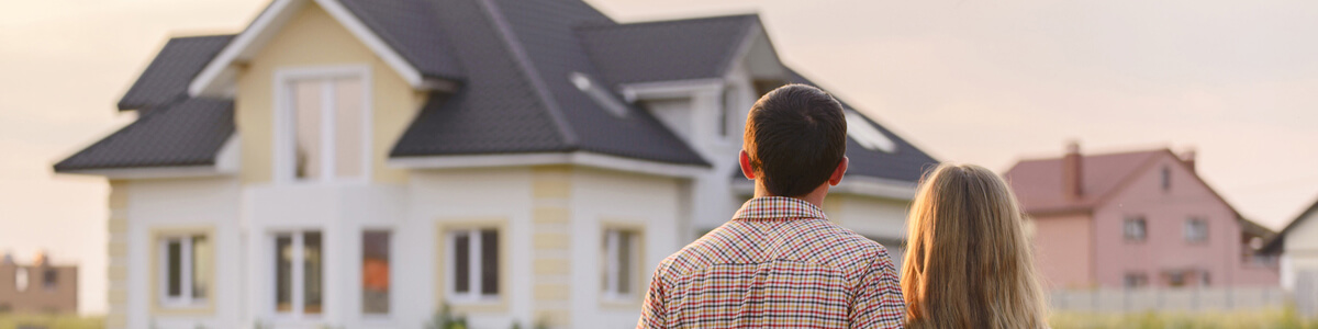 Couple Standing In Front Of a house